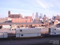 NACS containers stacked on a FEC flat car move on a BNSF train