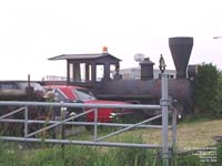 A modified automobile in a mock steam engine
