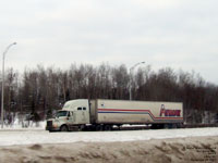 A QuikX tractor pulling an Armour trailer