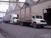 A International tractor truck parked behind a Mercedes straight body truck in Monterrey