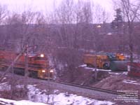 SLR train 394 passes Arlie C. Fearon Transport garbage trucks.