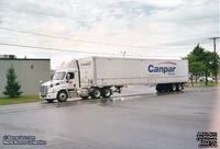 A Location Brossard tractor pulls a Canpar trailer